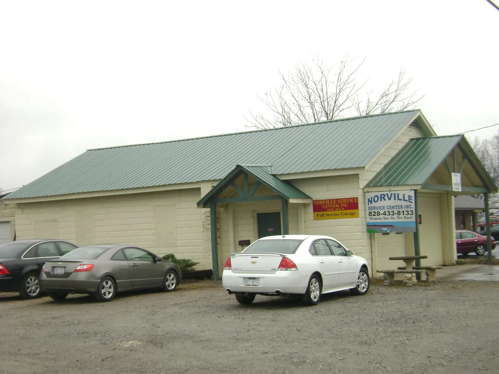 Green metal roof on a service garage with a covered entry in Linwood